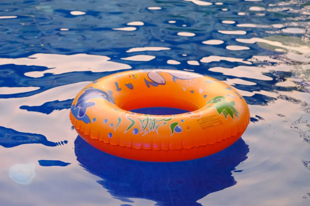 Soft sided inflatable pool with a blue liner in a summer yard