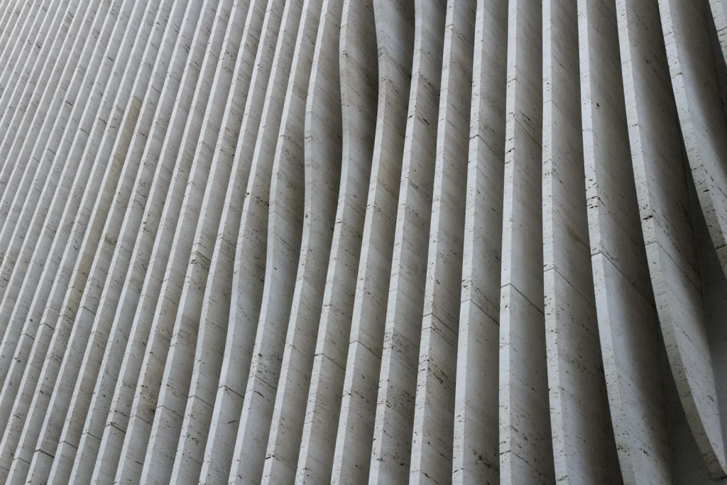 Pleated pool filter cartridge held up showing silt packed in folds