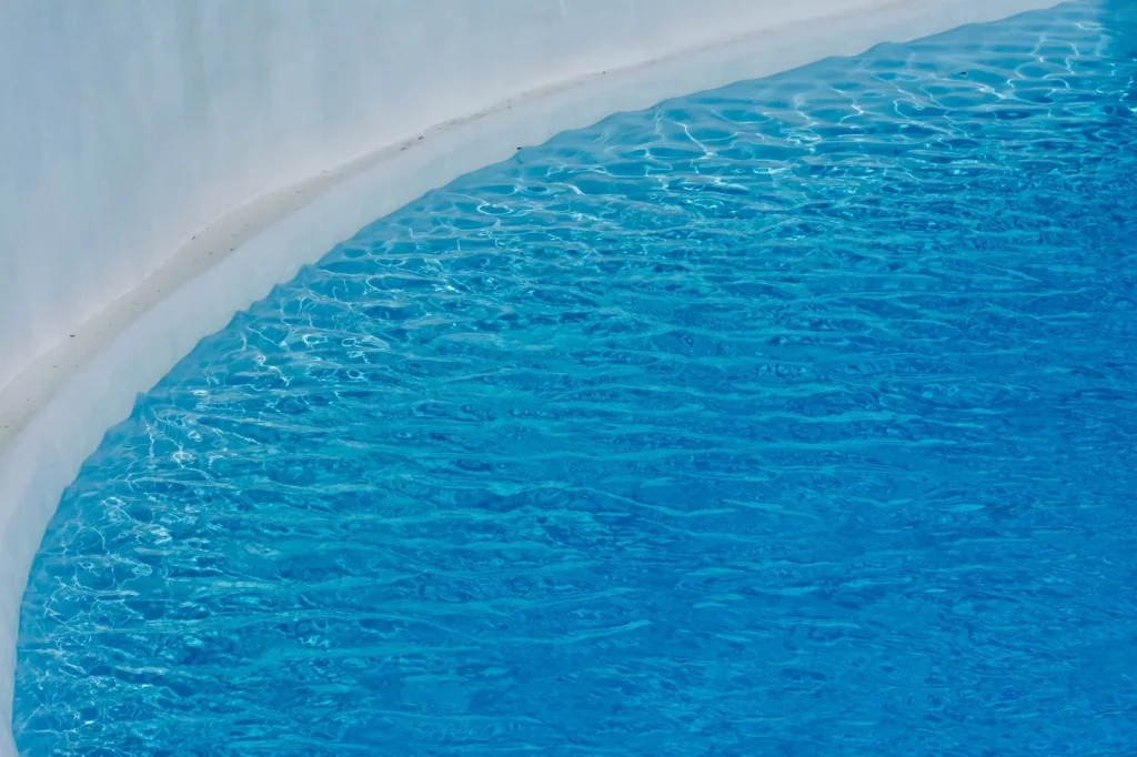 Gentle ripples along the waterline edge of a smooth pool shell