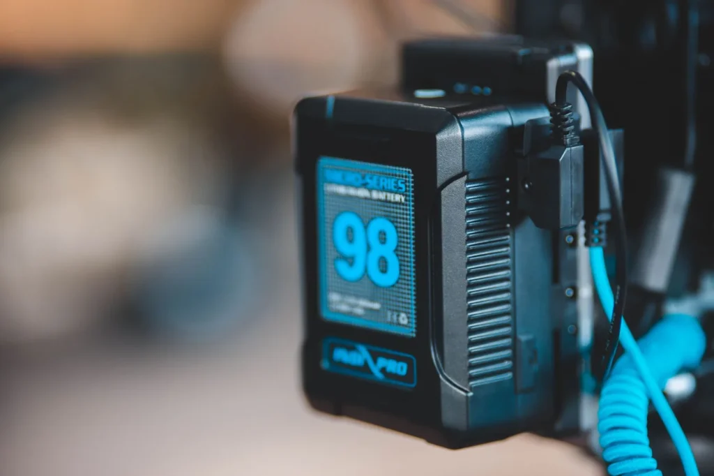 Close view of a glowing green charge indicator light on a pool robot battery pack