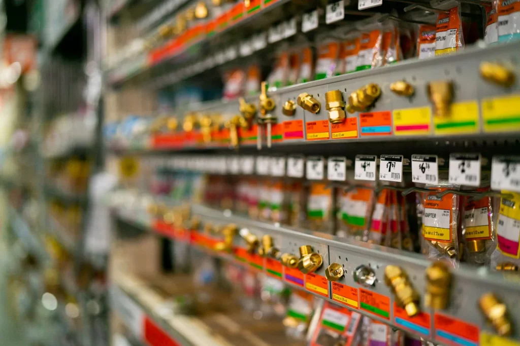 Small mechanical parts and screws organized in labeled plastic storage bins