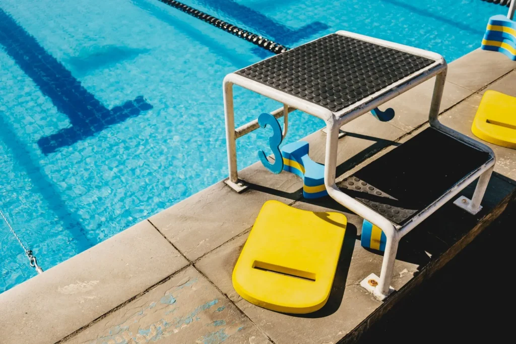 Pool filtration and salt chlorinator equipment mounted outside near a backyard pool