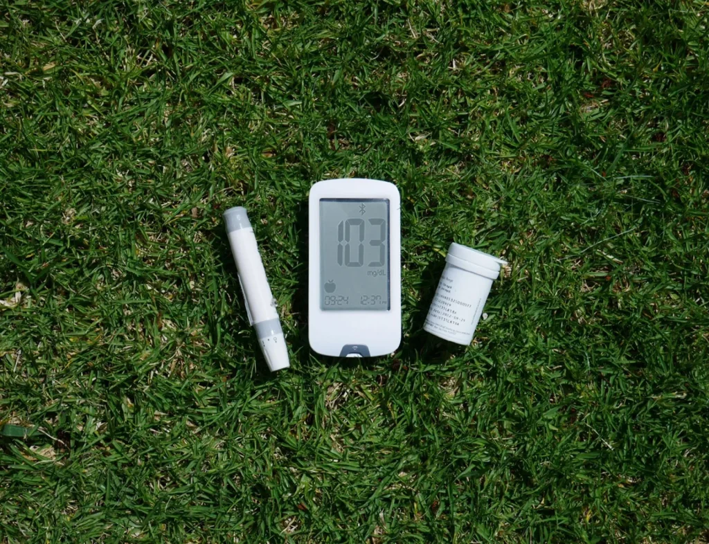 Salt and chlorine test strips laid beside a swimming pool edge