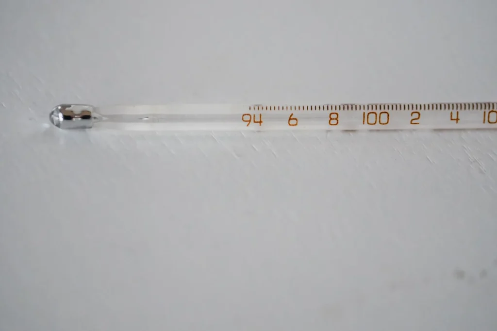 Floating thermometer showing water temperature at the surface of a pool