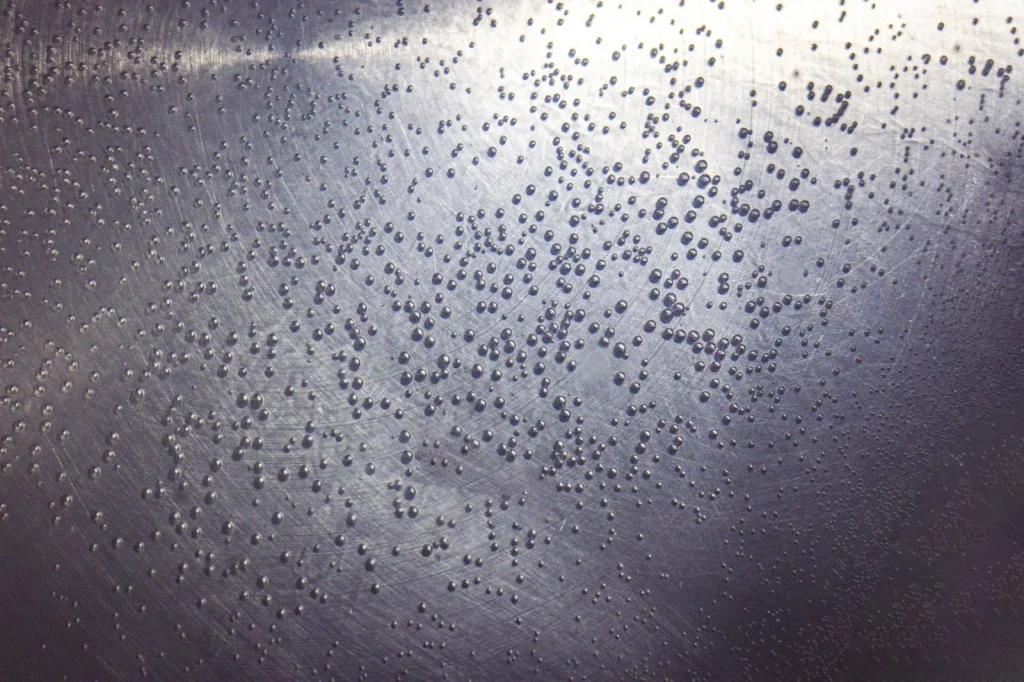Water bubbling and boiling at the surface above a submerged pool robot