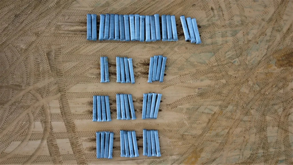 New replacement roller brushes and screwdriver laid out on workbench