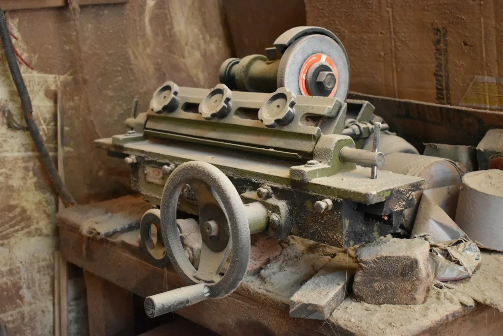 Worn machine parts laid out on a workbench for inspection