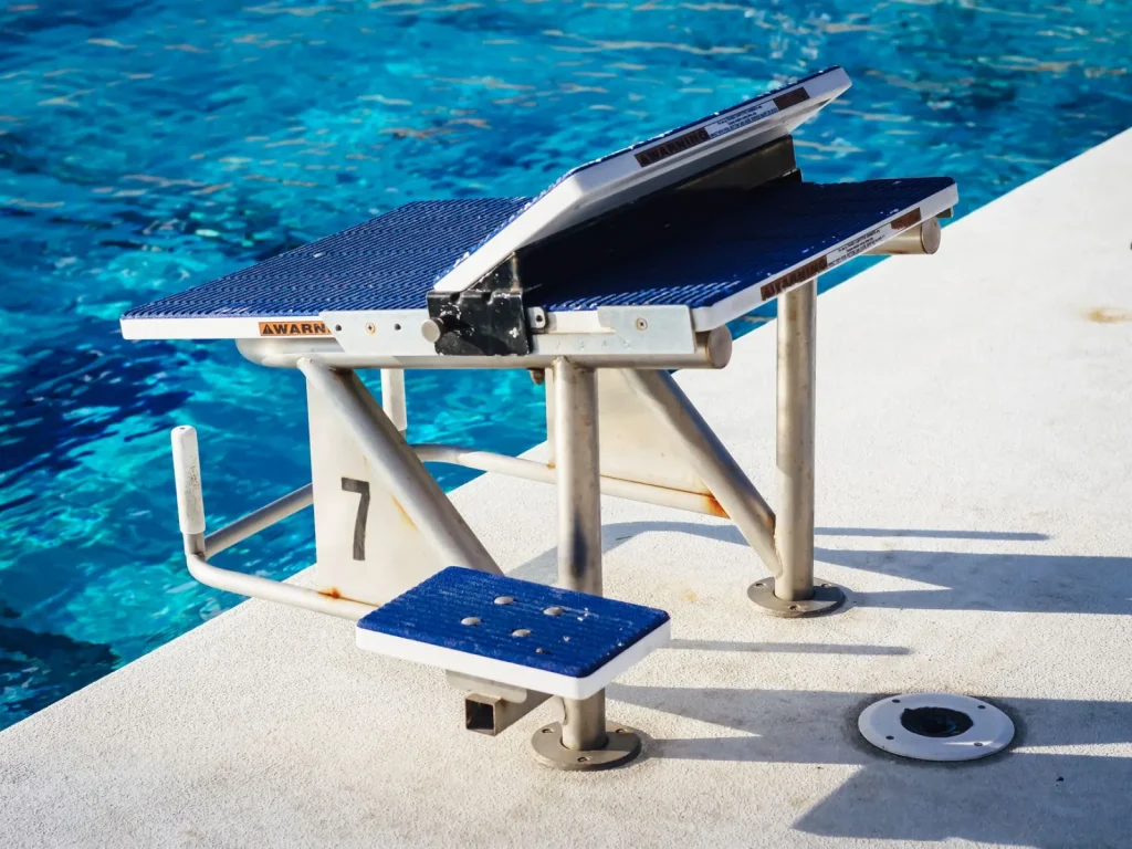 Pool pump and filter system installed on an equipment pad beside a backyard pool